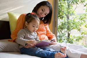 Mother and daughter reading book