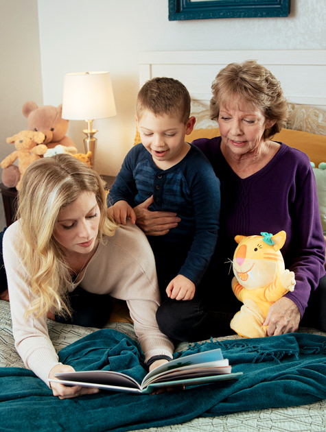 Mother and Grandmother reading to boy