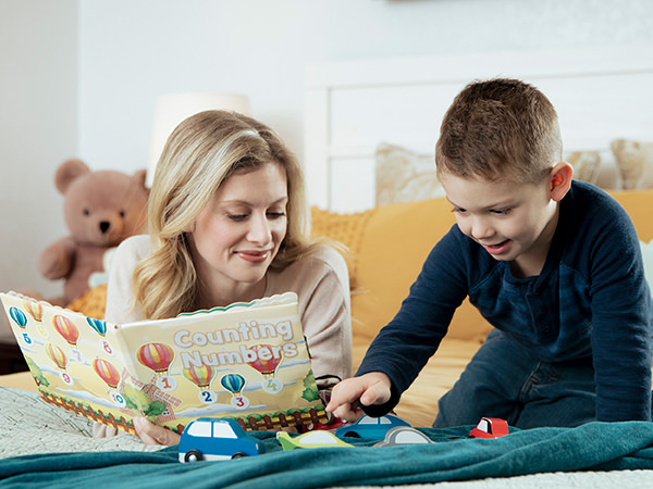 A mother reading a book to her young child