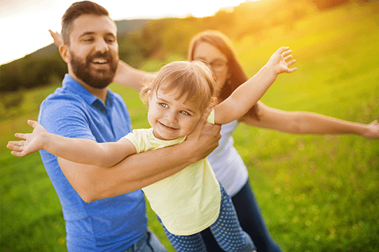 Caucasian parents playing with child