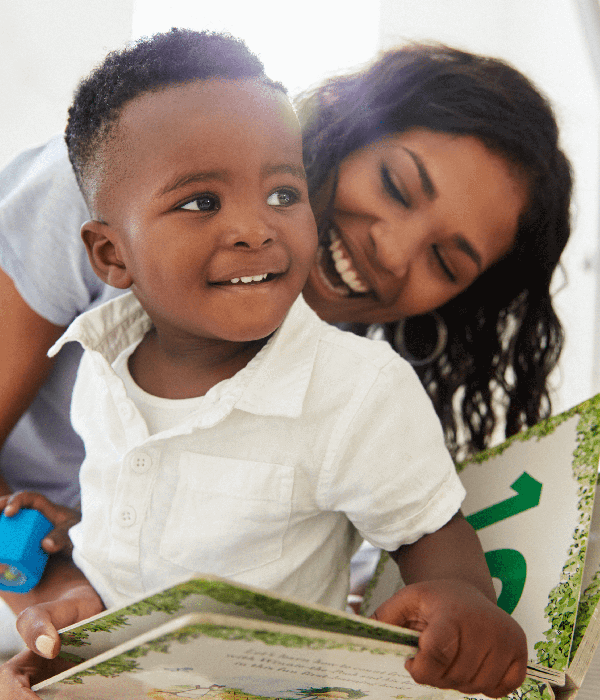 Parents reading a book to son